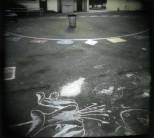 This is a photo I made for "Photo a Day" in 2008. I recently made a nice print and applied some Marshall's photo coloring pencils and paint. The bits of color kind of punch things up a little and draw attention to the chalk drawings on the asphalt. 