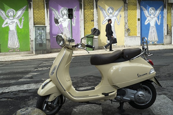 Vespa, street art and man in black, Lisbon, Portugal.